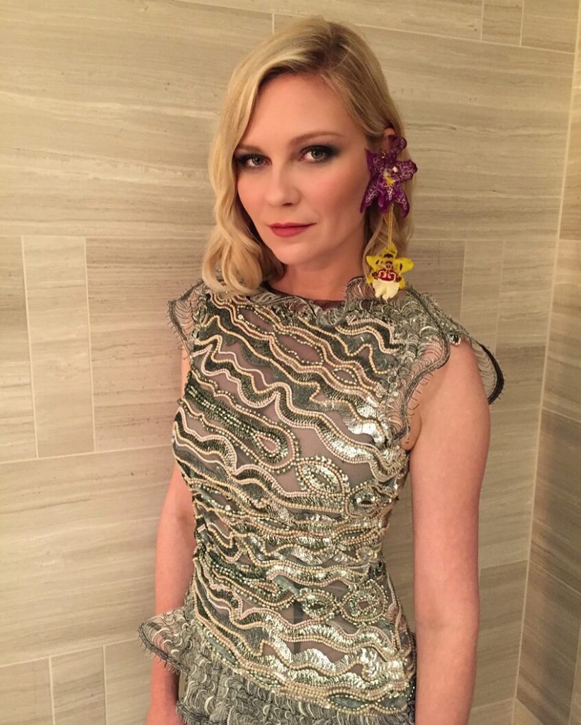 Kirsten Dunst wears earrings with real orchids by Rodarthe